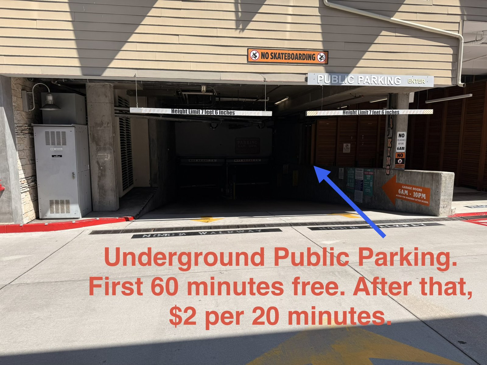Underground public parking garage entry with rates posted